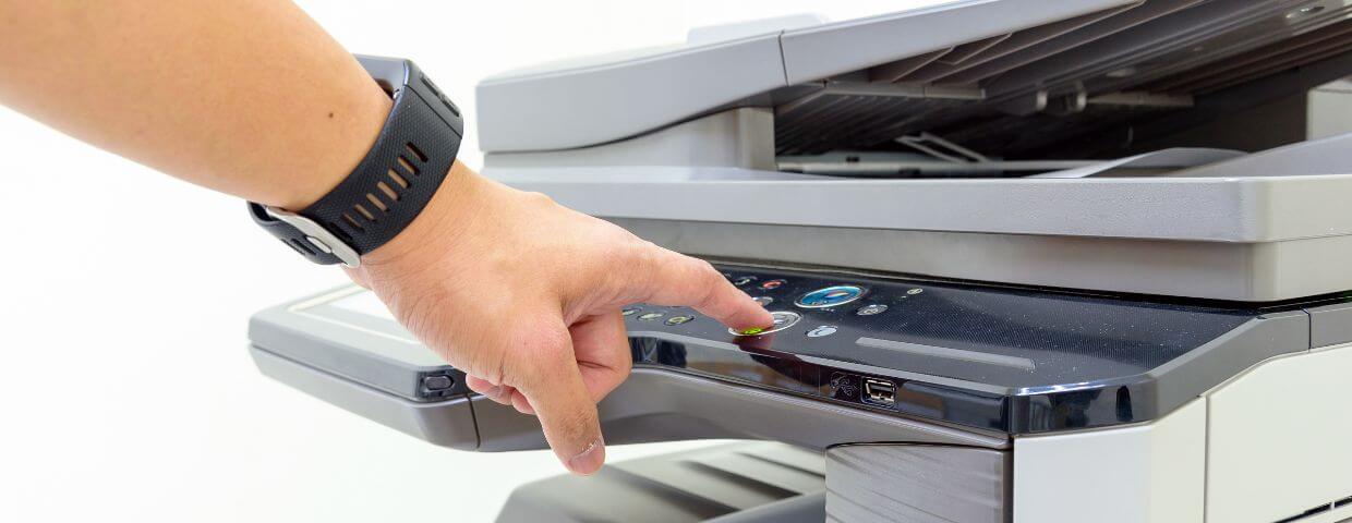 hand operating a multifunction printer